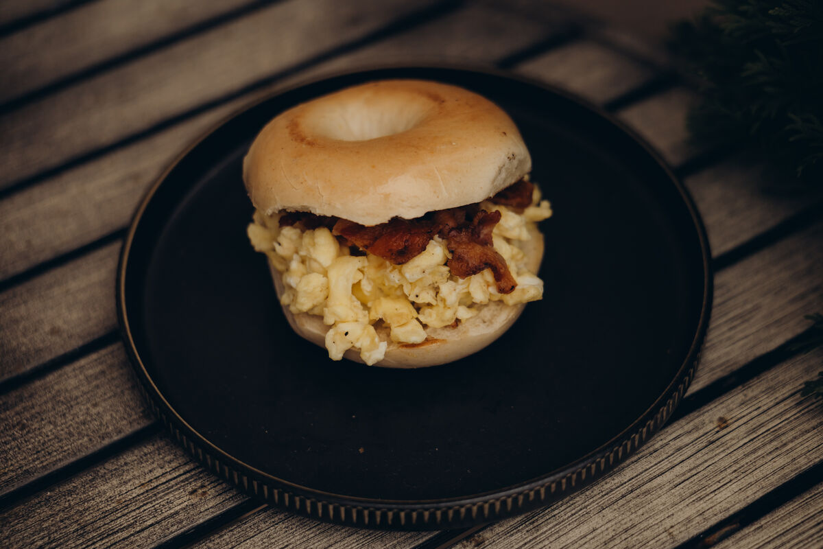 Bagel with eggs and bacon