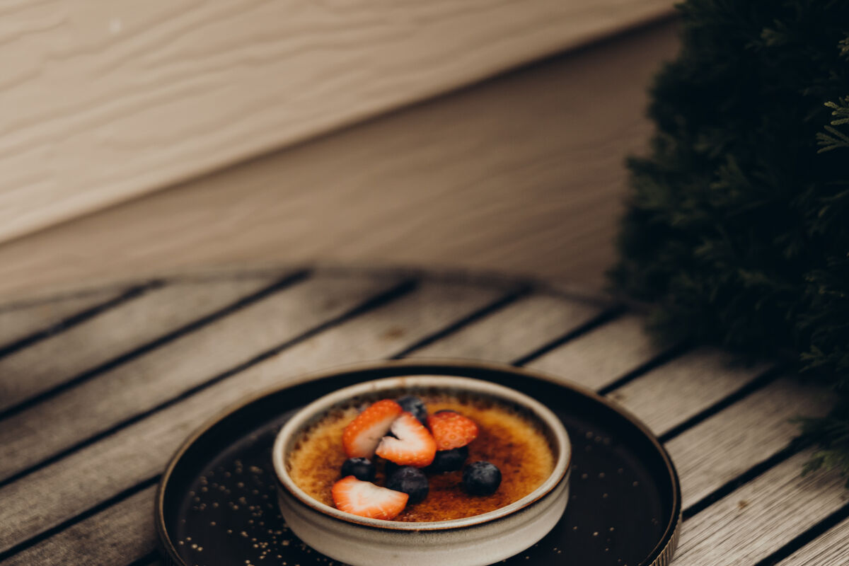 Crème brûlée torched tableside with berries